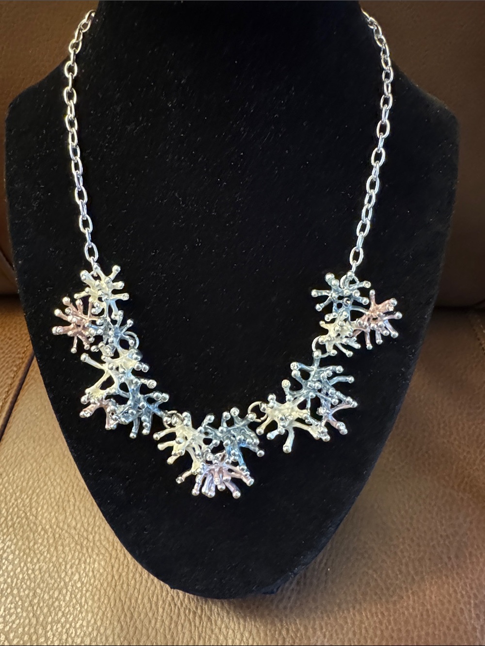 Silver tone coral shaped statement necklace w/shades of blue & pink